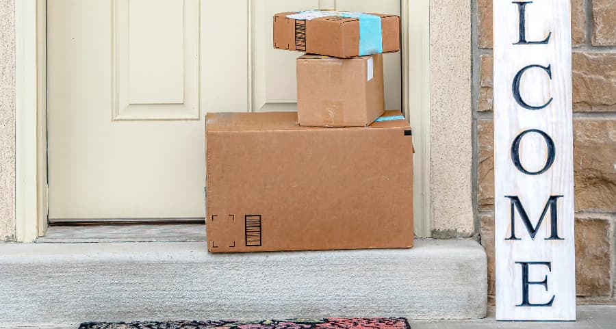 Boxes by the door of a residence with a welcome sign in South Fulton